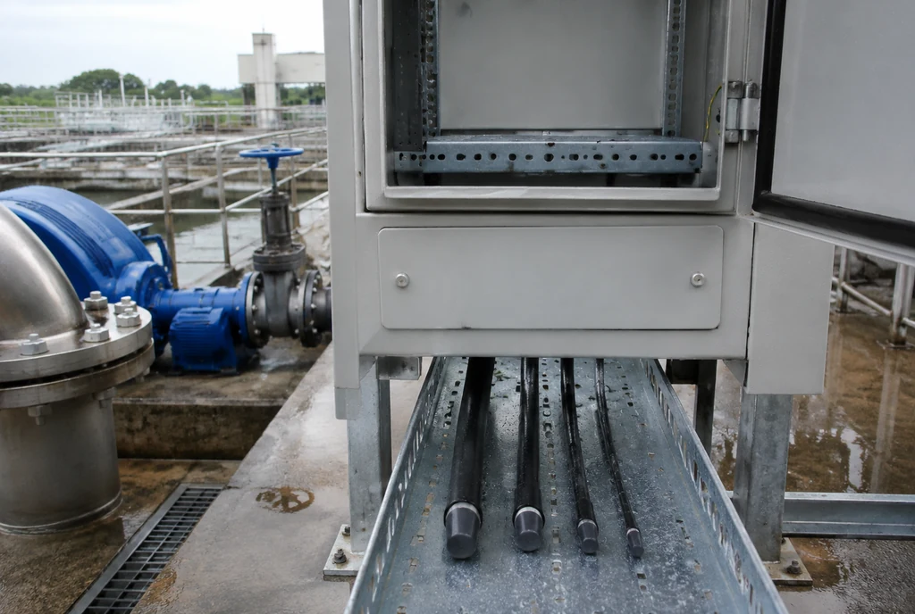 Outdoor water-treatment control cabinet and different cable sizes awaiting cable entry selection after rain